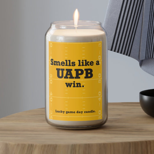 Arkansas Pine-Bluff candle with a yellow label on a wooden surface